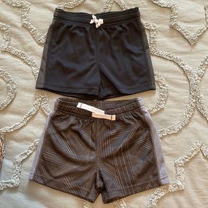 Two pairs of Boy toddler basketball shorts.